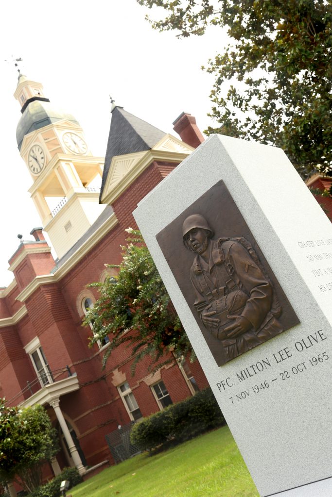 Lexington building and monument for PFC Milton Lee Olive